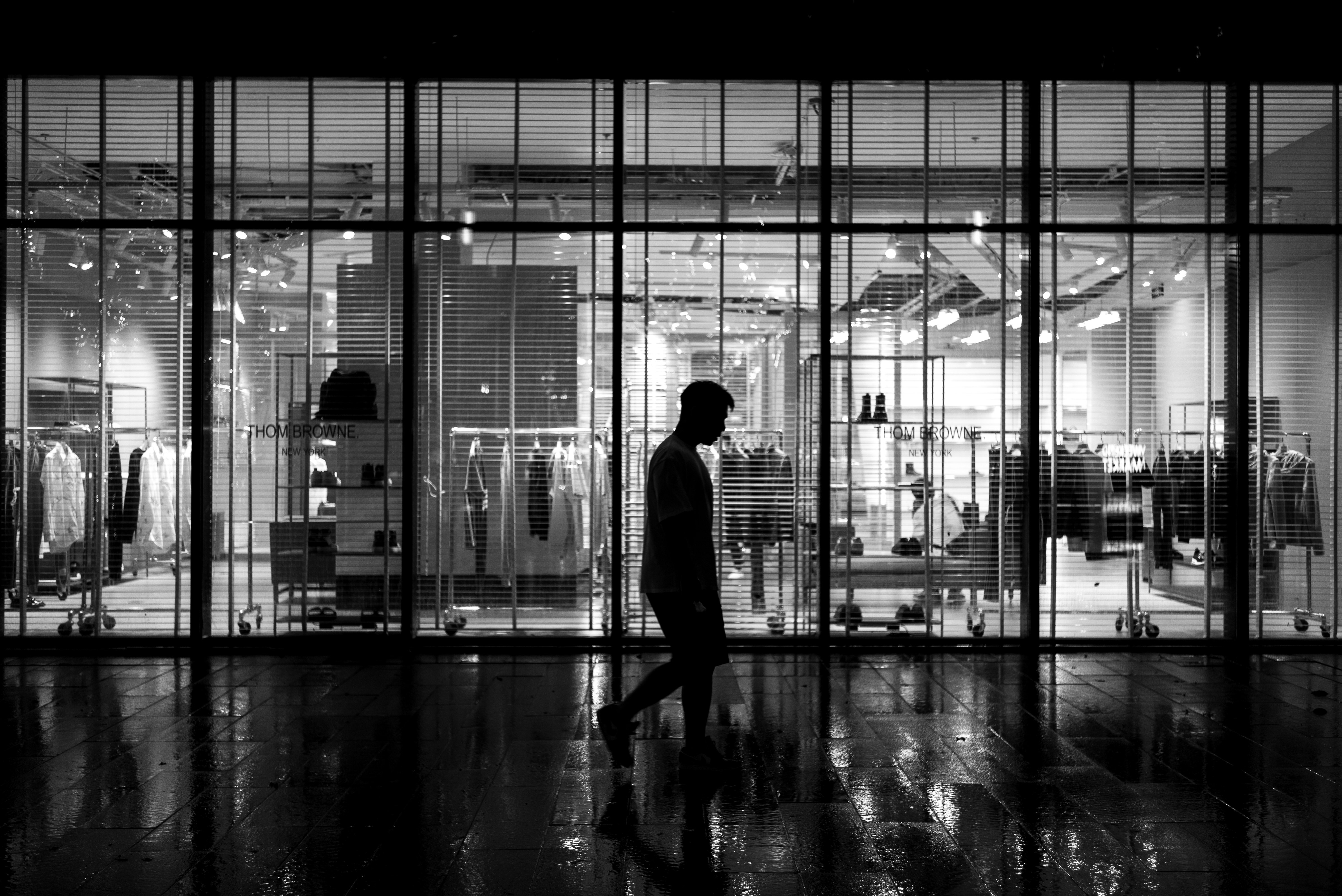 silhouette of person walking on sidewalk during daytime